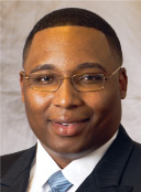 The current alderman, Jason Ervin, sits in the next room at a makeshift desk set up at the head of a conference room table. Portable cubicle walls separate ... - Jason-C-Ervin